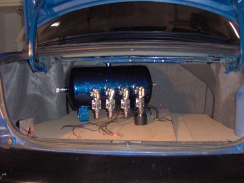 1996 Chevrolet Cavalier - Custom air suspension tank installed in the trunk of a car.