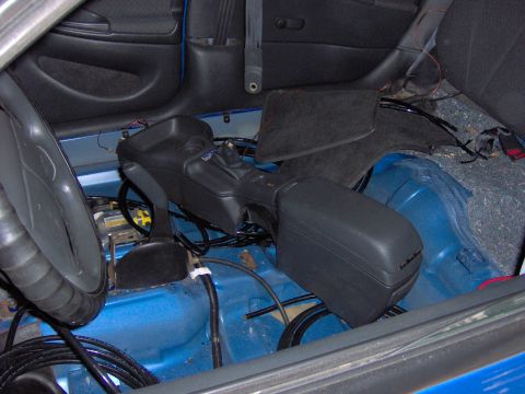 1996 Chevrolet Cavalier - Air ride suspension components are visible in the interior of this vehicle, with the center console and flooring removed.