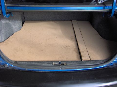 1996 Chevrolet Cavalier - Trunk interior of a 1996 Chevrolet Cavalier showing custom wood paneling.