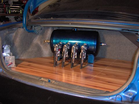 1996 Chevrolet Cavalier - Custom air suspension components installed in the trunk of a vehicle.