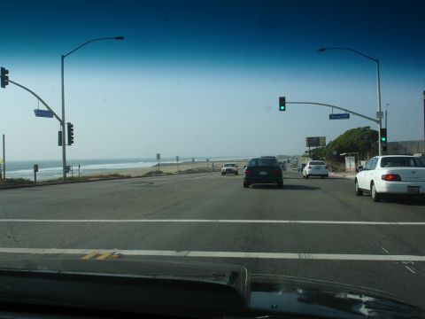 1993 Ford Taurus - Highway driving scene with multiple vehicles and a view of the ocean.