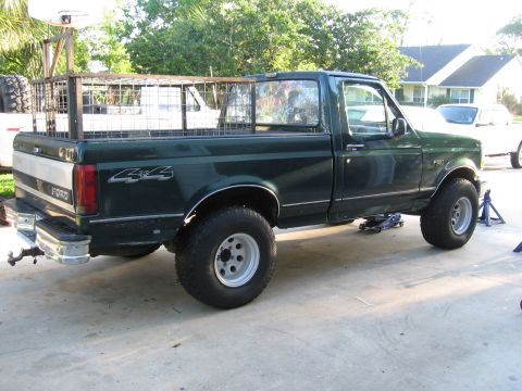 1974 Ford F-100 - This Ford F-150 pickup truck is being worked on, with a custom cage installed in the bed.