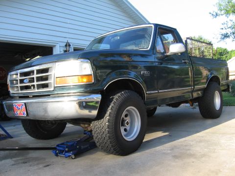 1974 Ford F-100 - This Ford F-150 pickup truck is being worked on, with a jack supporting the front end.