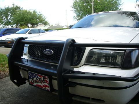 2000 Ford Crown Victoria - Front view of a 2000 Ford Crown Victoria equipped with a push bar and a DARE license plate.
