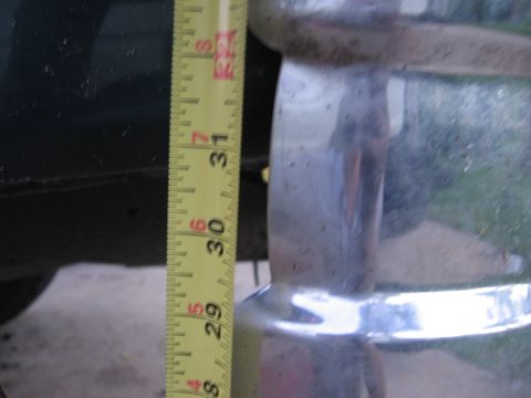 1974 Ford F-100 - A tape measure is held against a chrome bumper, indicating measurements between 29 and 31 inches.