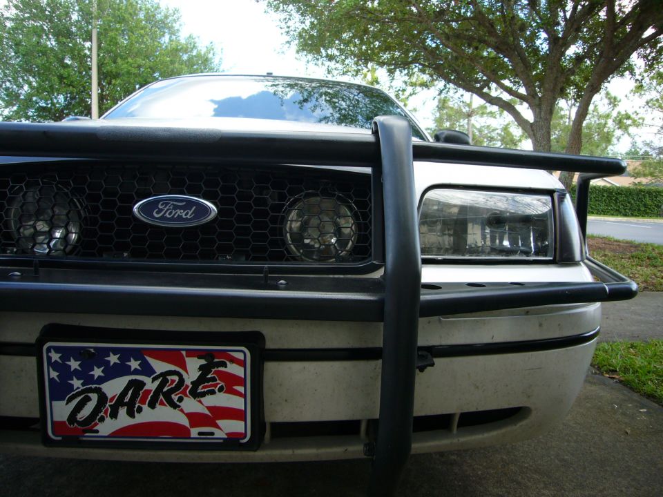 Front view of a 2000 Ford Crown Victoria with a push bar and D.A.R.E. license plate