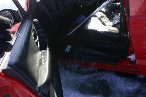 2003 Jeep TJ - 2003 Jeep TJ interior is partially submerged in water, with the driver's door open.
