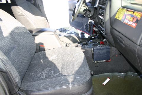 2003 Jeep TJ - Interior view of a 2003 Jeep TJ, a CB radio and some water on the floor.