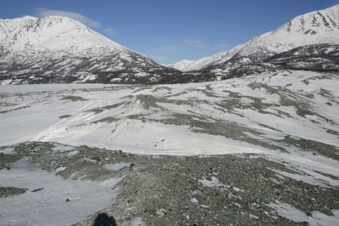 2003 Jeep TJ - A wide view of a snowy mountain landscape with rocky foreground and distant peaks.