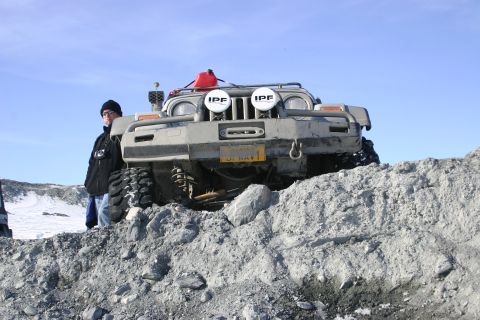 2003 Jeep TJ - A 2003 Jeep TJ sits on a rocky hill under a clear blue sky.