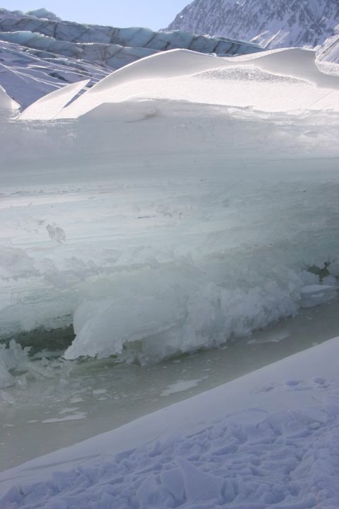 2003 Jeep TJ - Ice formations on a glacier under a clear blue sky with mountains visible.