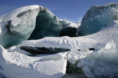 2003 Jeep TJ - A natural ice cave formation under a clear blue sky.