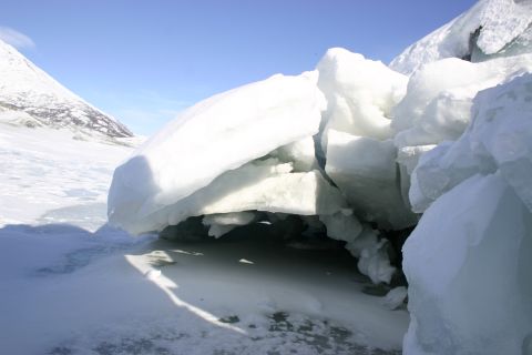 2003 Jeep TJ - Large, broken ice formations dominate the foreground of a snow-covered landscape with a mountain in the background.