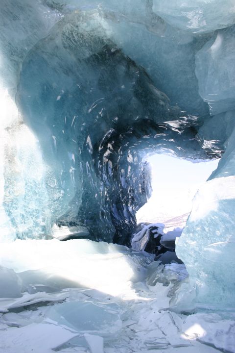 2003 Jeep TJ - Sunlight illuminates the interior of a natural ice cave, revealing formations of blue ice.