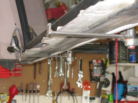 1996 Ford Bronco - Close-up view of vehicle undercarriage components and a pegboard with various tools in a workshop setting.