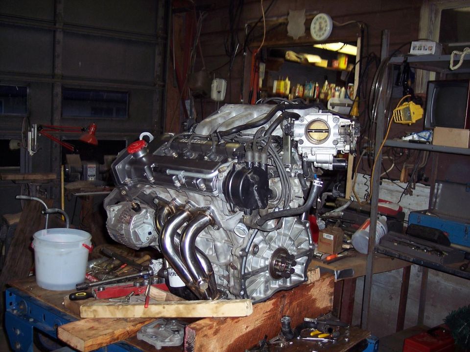 Engine with chrome headers and intake manifold on workbench