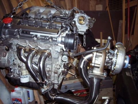 1995 Ford Probe - Engine with turbocharger and custom exhaust manifold, likely for performance modification.