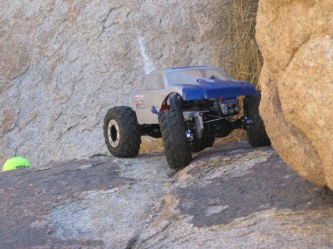 1985 Ford Bronco - An RC rock crawler navigates a rocky terrain, its off-road capabilities.