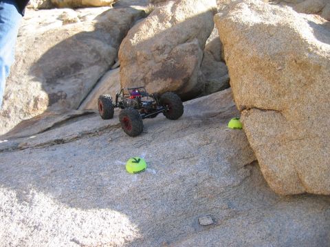 1985 Ford Bronco - RC rock crawler navigating a challenging obstacle course marked by tennis balls.