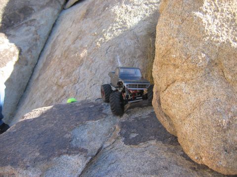 1985 Ford Bronco - A remote control truck navigates a rocky terrain.