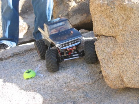 1985 Ford Bronco - A remote control monster truck navigates a rocky terrain.