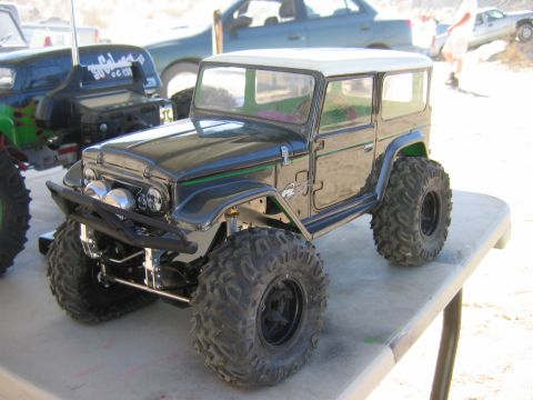 1985 Ford Bronco - A detailed remote-controlled vehicle with off-road tires is displayed outdoors.