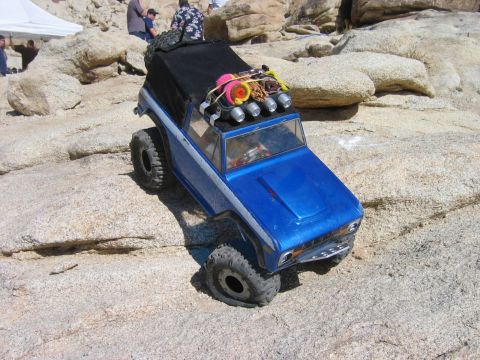 1985 Ford Bronco - This blue remote control rock crawler truck is equipped for off-road adventures with large tires and a roof rack.