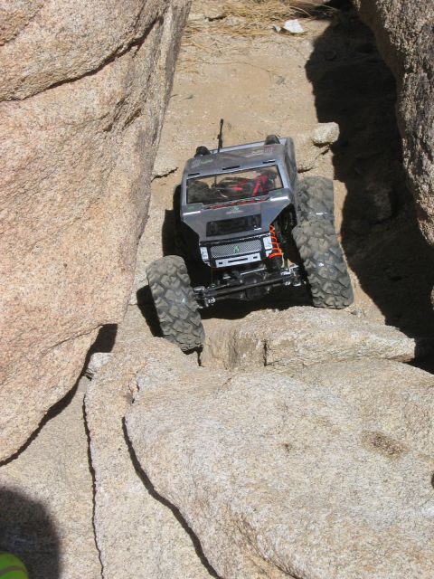 1985 Ford Bronco - RC rock crawler truck maneuvers through a narrow, rocky path.