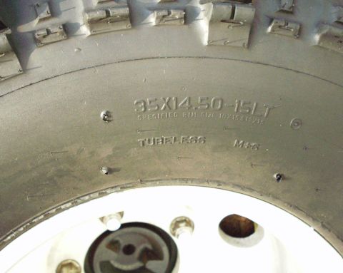 1989 Ford Bronco - A close-up view of a tire and wheel assembly, showing tire size and 'Tubeless M+S' markings.