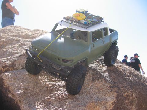 1985 Ford Bronco - A remote-controlled off-road vehicle navigates a rocky incline under a bright sky.
