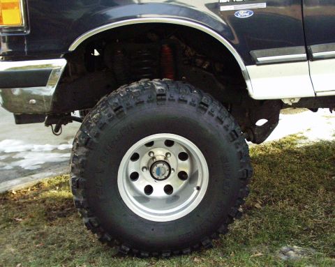 1989 Ford Bronco - Close-up of the front wheel and fender of a 1989 Ford Bronco.