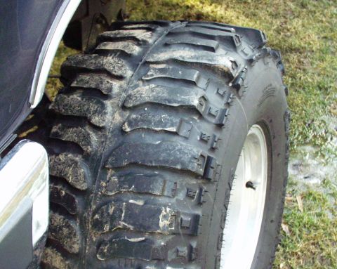 1989 Ford Bronco - Close-up of a large off-road tire mounted on a vehicle wheel.