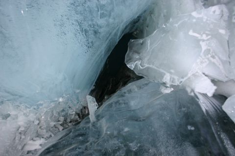 2003 Jeep TJ - A close-up view of fractured ice formations revealing a dark opening within.