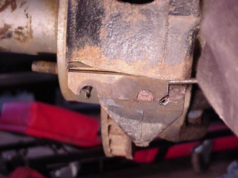 1992 Ford Bronco - remove the caliper, by removing the bolt, then punching out the spacer.