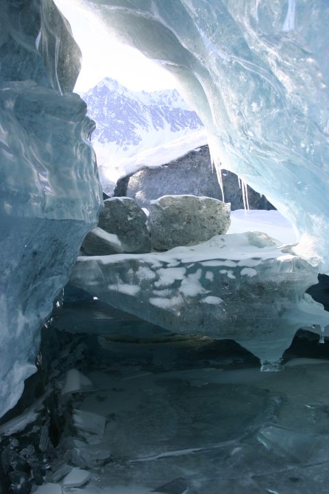 2003 Jeep TJ - Looking out from within a glacial ice cave at the , snow-capped mountains beyond.