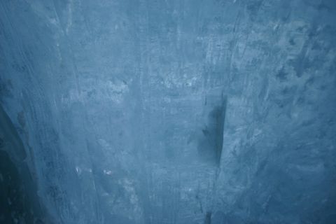 2003 Jeep TJ - A close-up view of a textured blue ice wall, showing natural formations and shadows.