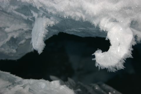 2003 Jeep TJ - Close-up of ice formations with sharp, crystalline edges hanging over a dark, reflective surface.