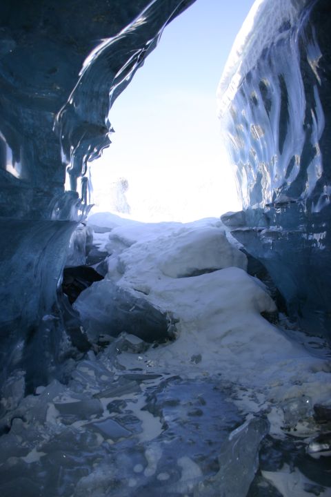 2003 Jeep TJ - View from within a glacial ice cave, showing the path leading to the sunlit exit.