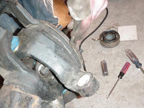 1992 Ford Bronco - remove tie rod, the remove spindle and caliper bracket by prying on both sides with a chisel. spindle pullers are available.