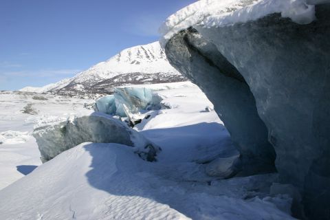 2003 Jeep TJ - Winter scene at a glacier with icy formations and a distant snow-capped mountain.