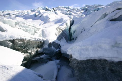 2003 Jeep TJ - A vast expanse of ice and snow forms deep crevasses, illuminated by sunlight on a clear day.