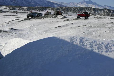 2003 Jeep TJ - Multiple off-road vehicles navigate a snowy, mountainous landscape.
