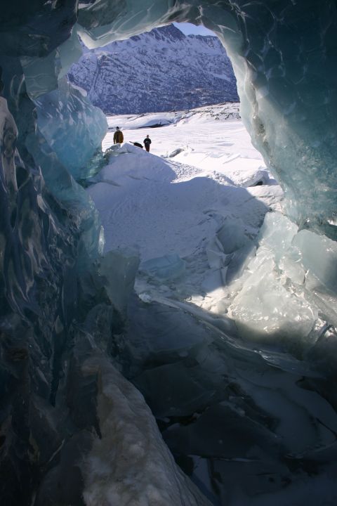 2003 Jeep TJ - Looking out from an ice cave at Knik Glacier, Alaska, with two figures visible in the distance.