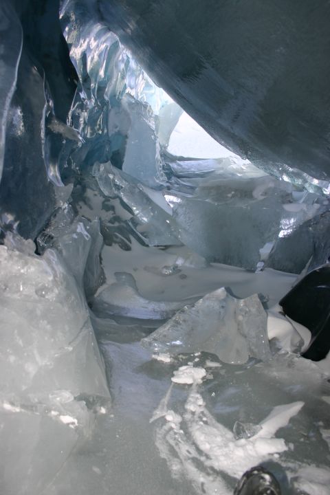 2003 Jeep TJ - Inside an ice cave, showing fractured ice and snow under a bright opening.