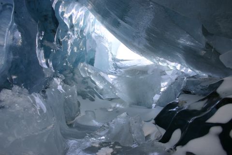 2003 Jeep TJ - The interior of an ice cave shows formations of ice and snow with light filtering from above.