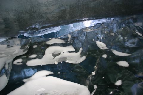 2003 Jeep TJ - Interior of an ice cave showing the textures and colors of the ice and snow.