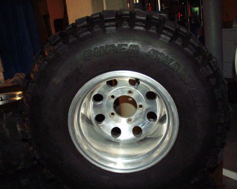 1989 Ford Bronco - A Super Swamper tire with a chrome rim is shown, with "SUPER MOTORS" visible at the bottom.