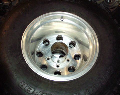 1989 Ford Bronco - A single aluminum wheel and tire are shown in this close-up photograph.