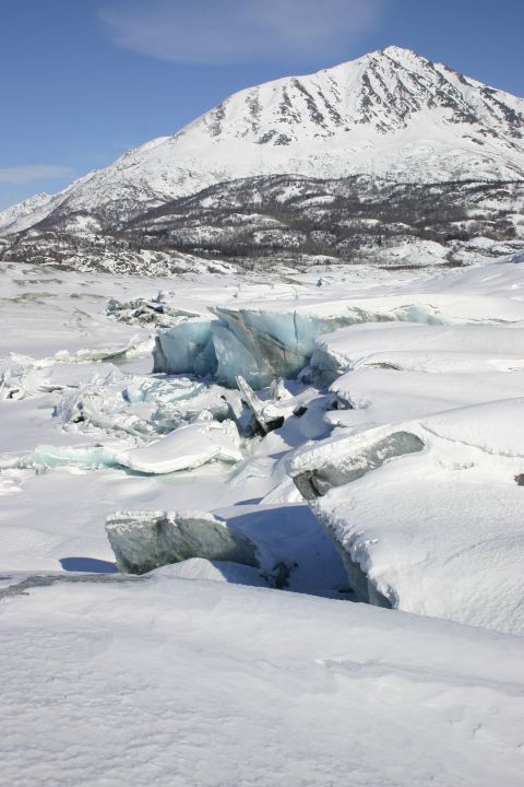 2003 Jeep TJ - A vast, snow-covered mountain looms over a broken glacier and icy terrain on a clear day.