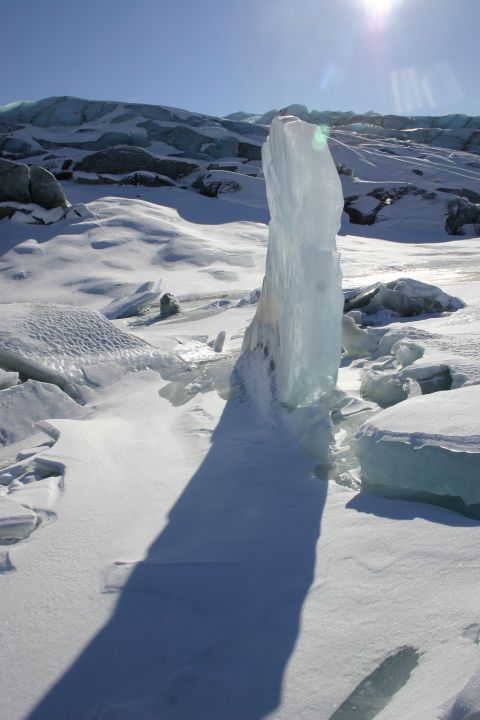 2003 Jeep TJ - A tall ice formation stands out against a snowy landscape under a bright sun.